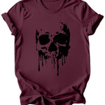 A maroon short-sleeve crewneck t-shirt featuring a black dripping skull graphic on the front, displayed against a solid white background.