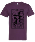 Purple t-shirt with a graphic of a witch and cat, labeled 'The Witch', on a white background.