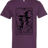 Purple t-shirt with a graphic of a witch and cat, labeled 'The Witch', on a white background.