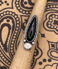 Artisan handmade sterling silver ring with teardrop shaped black onyx gemstone.
