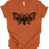An orange short-sleeve crewneck t-shirt with a black decorative moth graphic printed on the chest, displayed flat against a white background.