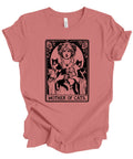 A dusty rose short-sleeve t-shirt with a vintage-style graphic print of a woman holding three black cats, captioned 'MOTHER OF CATS' in an Art Nouveau design. The shirt is shown flat against a plain white background.