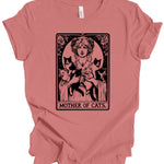 A dusty rose short-sleeve t-shirt with a vintage-style graphic print of a woman holding three black cats, captioned 'MOTHER OF CATS' in an Art Nouveau design. The shirt is shown flat against a plain white background.