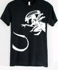 Black t-shirt with a white alien graphic on a hanger against a white background