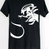 Black t-shirt with a white alien graphic on a hanger against a white background