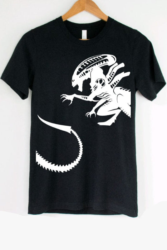 Black t-shirt with a white alien graphic on a hanger against a white background